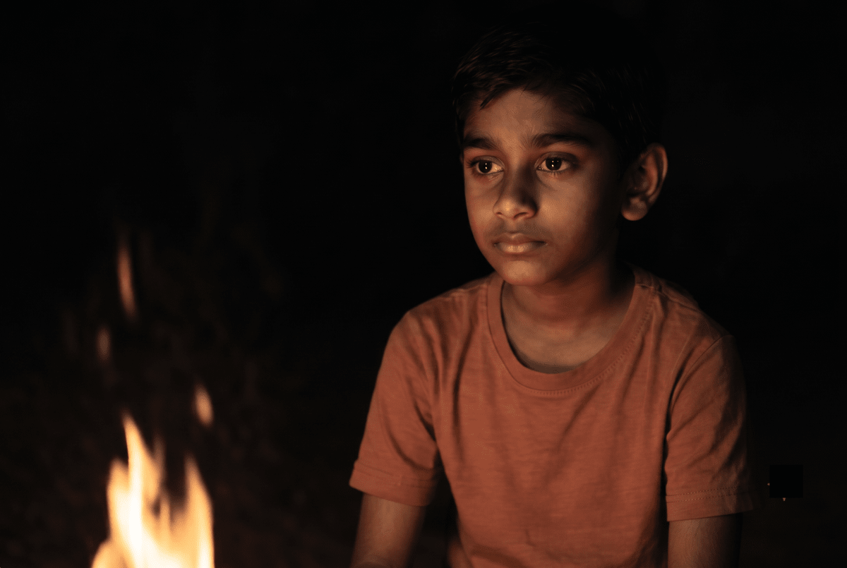 Satvik sat beside the campfire on a chilly evening. He noticed that even though the fire was small, he could feel warmth from a distance. He wondered why the iron chair he sat on felt colder than the wooden log, though both were outside for the same time. His sister explained, Its because metal conducts heat faster than wood. Thats why metal feels colder or hotter. As he held his hands near the fire, he didnt touch the flames but still felt warm. He thought, If the air doesnt touch me directly, how do I feel warm? Heat, Viva Physics Solutions ICSE Class 6.